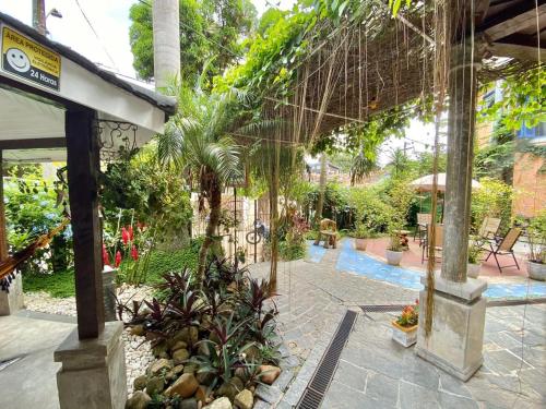 a courtyard with trees and plants in a building at Vila Pequeá Pousada Ilhabela in Ilhabela