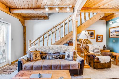 a living room with wooden ceilings and a staircase at Aspenwood 4259 in Pagosa Springs