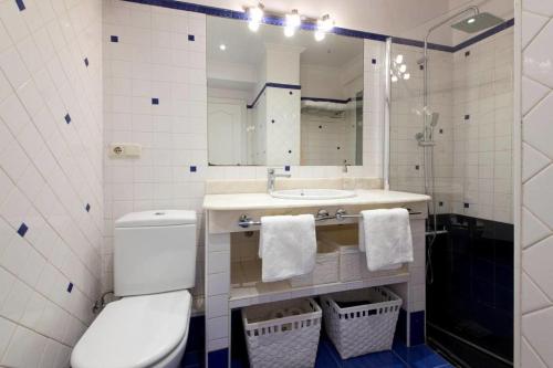 a bathroom with a toilet and a sink and a mirror at ONDARRETA ROOM with independent entrance in San Sebastián