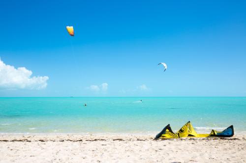 a kite laying on the beach next to the ocean at H2O LifeStyle Resort in Long Bay Hills