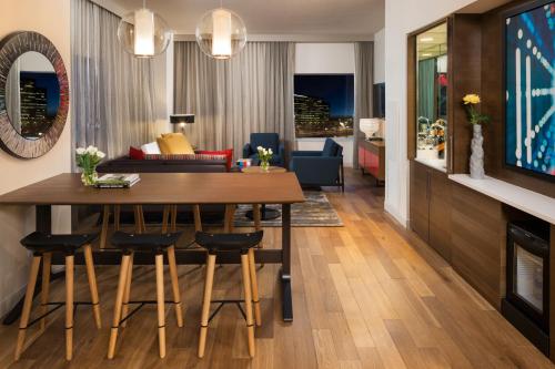 a dining room and living room with a table and chairs at Hyatt Regency Bloomington - Minneapolis in Bloomington