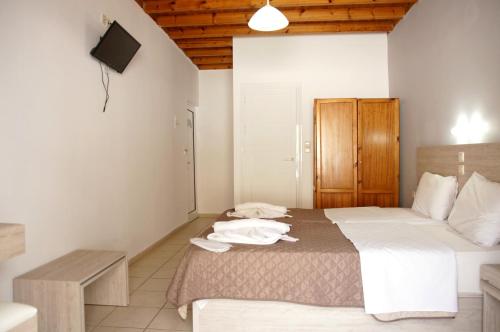 a bedroom with a bed with towels on it at Αnna in Loutro