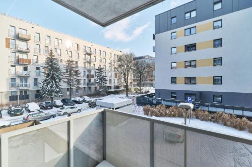 an apartment balcony with a view of a parking lot at Promenady Green Apartments by Renters in Wrocław