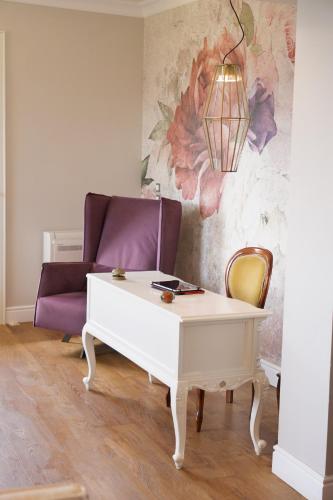 a living room with a white coffee table and a purple couch at Agnantia Bed & Breakfast in Fiskardho