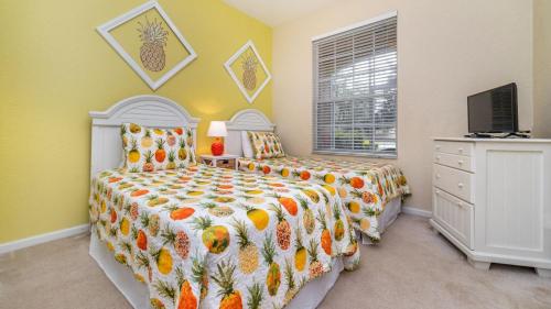 a bedroom with two beds and a television in it at Beautiful 5 Star Condo on the Prestigious Windsor Hills Resort, Orlando Condo 4791 in Orlando