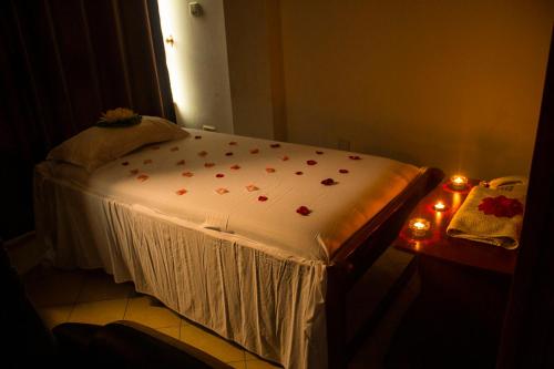a bed with a white sheet with hearts on it at New Hotel Aquiline in Arusha