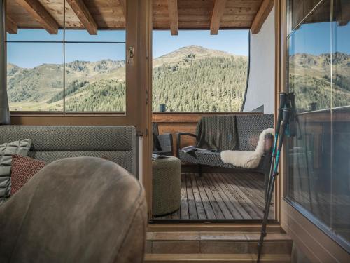 a screened in porch with a view of mountains at Montana Hochfügen in Hochfugen