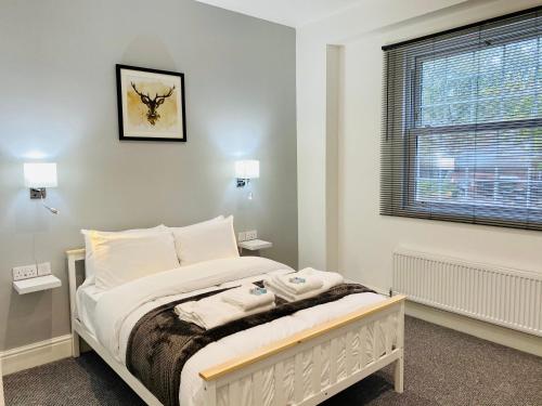 a bedroom with a bed and a window at Higher Lane House in Plymouth
