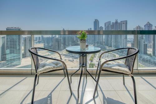 a table and two chairs on a balcony with a view at Prime Retreats - Downtown Dubai in Dubai