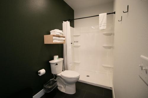 a bathroom with a toilet and a shower at LOGE Leavenworth Downtown in Leavenworth