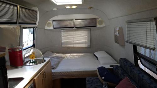 a small bedroom in an rv with a bed at Airstream in the Center of it All - RG in Miami