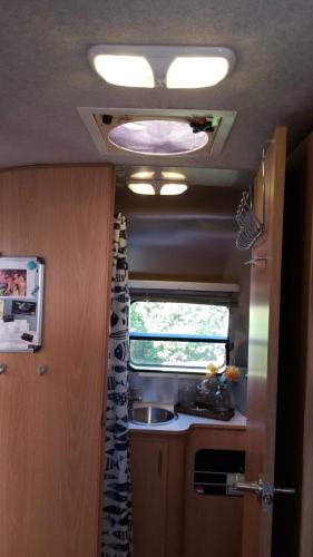 a kitchen in an rv with a sink and a window at Airstream in the Center of it All in Miami