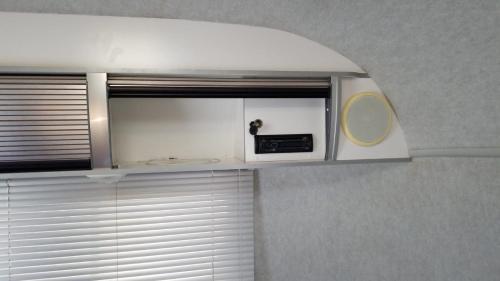 a kitchen with a window with a microwave on top of it at Airstream in the Center of it All in Miami
