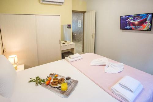 a room with a bed with a tray of food on it at Rent House Diamond in Iraklitsa