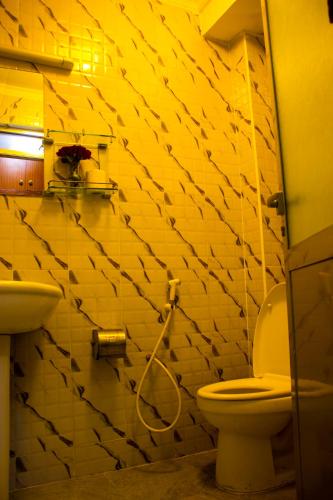 a bathroom with a toilet and a sink at New Hotel Aquiline in Arusha