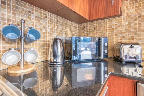 a kitchen with a counter top with a coffee maker at Prime Retreats - Downtown Dubai in Dubai
