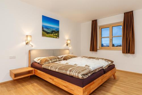 a bedroom with a bed in a room at Chiemgauferienwohnungen - Maier in Unterwössen