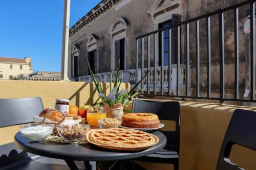 a table with food on top of a balcony at B&B Carlo V in Crotone