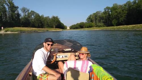 a man and woman in a boat on the water at Chiemgauferienwohnungen - Wanderlust und Alpenrose in Unterwössen