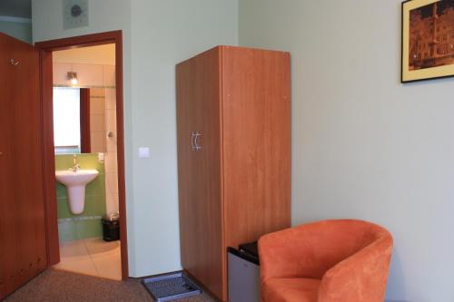 a bathroom with a chair and a cabinet and a sink at Moravia in Krzanowice