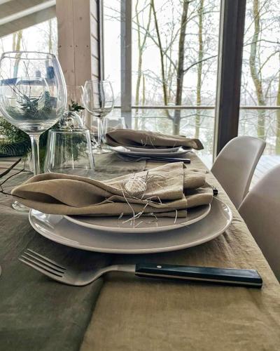 a table with plates and napkins and glasses on it at Bohemian Homes - Buddha in Horní Podluží