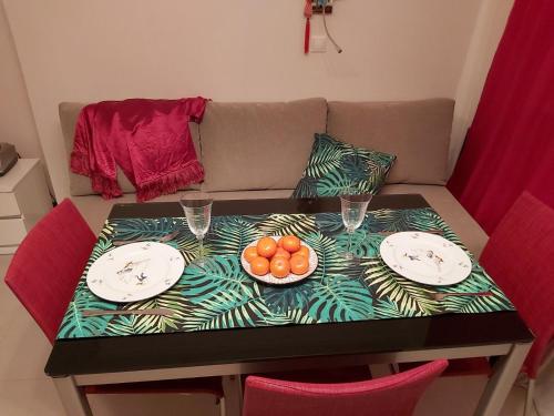 a table with plates and bowls of fruit on it at Lux Apartment, Liko Grad in Kyiv