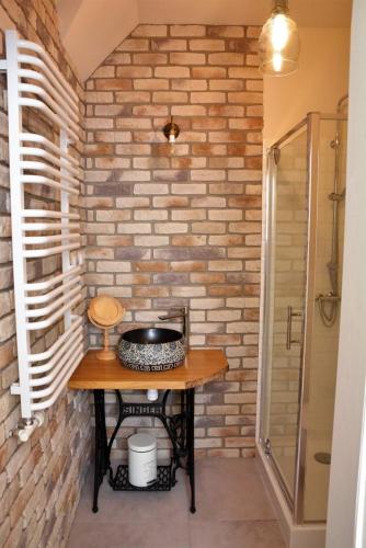 a bathroom with a wooden table and a shower at Lawendowe Siedlisko in Suwałki