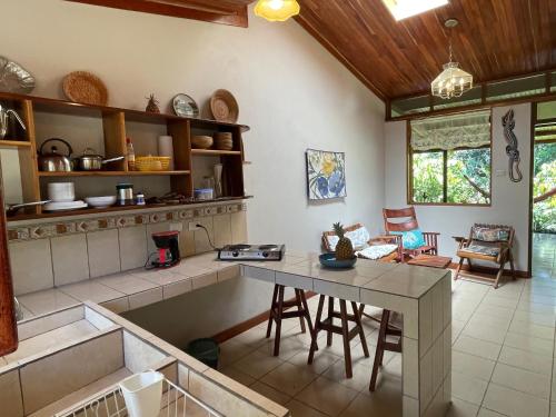 a kitchen with a table and chairs in a room at Finca Isla Rainforest Retreat in Aguas Zarcas