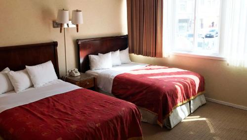 Ένα ή περισσότερα κρεβάτια σε δωμάτιο στο Pacific Heights Inn