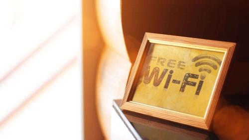 a picture of a free wifi sign in a frame at Magnuson Hotel Extended Stay Canton Ohio in Lake Cable