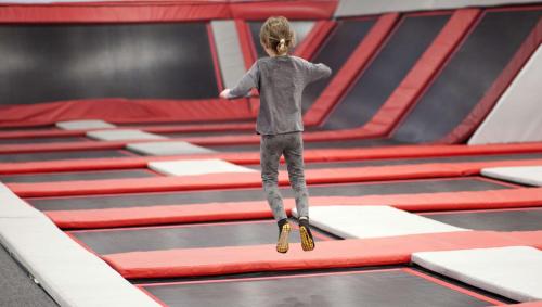 a young child is jumping on a trampoline at Magnuson Hotel Extended Stay Canton Ohio in Lake Cable
