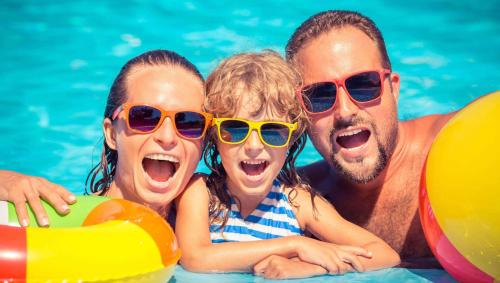 a group of people in a swimming pool wearing sunglasses at Magnuson Hotel Jacksonville Downtown in Jacksonville