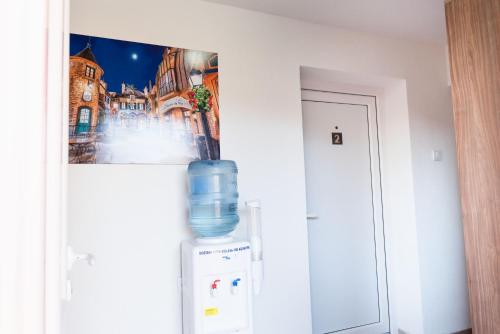 a water bottle is sitting on top of a refrigerator at APARTMANI CENTAR LUX NEW in Zrenjanin