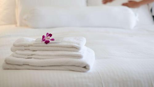 a pile of towels sitting on top of a bed at Alma Motel in Alma