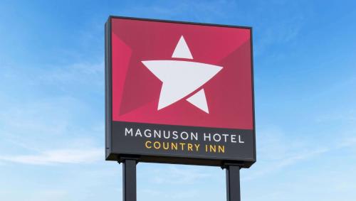 a sign for a maslow hospital country inn at Magnuson Hotel Country Inn in Ishpeming