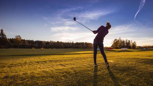 a woman swinging a baseball bat in a field at Pleasant Valley Motel West Stockbridge in West Stockbridge