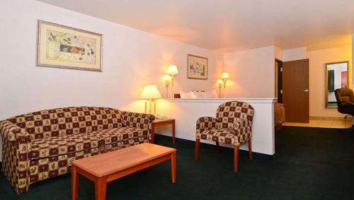 a hotel room with a couch and a chair at Magnuson Hotel Manitou Springs in Manitou Springs