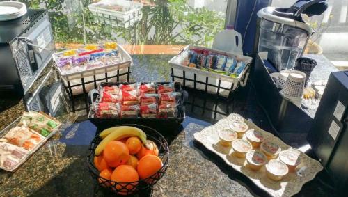 a counter topped with baskets of fruit and other food at Magnuson Hotel & Marina New Port Richey in New Port Richey