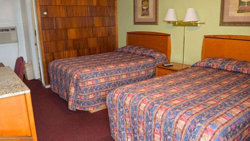 a hotel room with two beds in a room at Relax Inn Bloomsburg in Bloomsburg