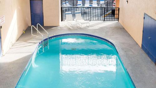 a swimming pool in the middle of a building at Magnuson Hotel Bradenton in Bradenton