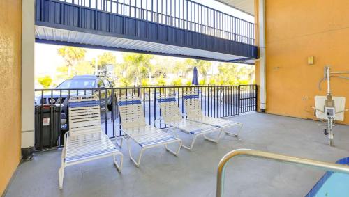 a group of chairs sitting on a balcony at Magnuson Hotel Bradenton in Bradenton