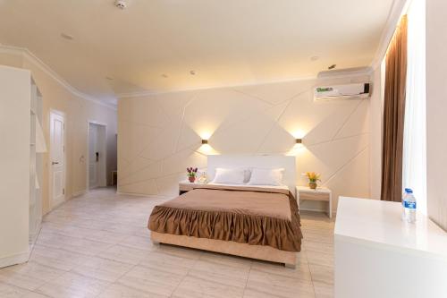 Postel nebo postele na pokoji v ubytování Tantana Hotel