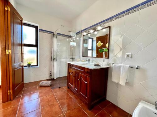 a bathroom with a sink and a mirror at Villa Pilar in Playa Blanca