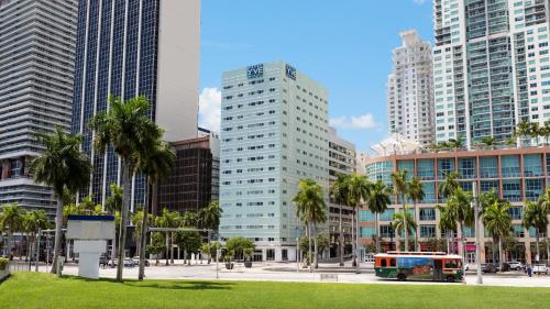 a bus in a city with tall buildings at YVE Hotel Miami in Miami