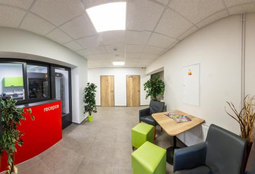 an office with a table and chairs and plants at Penzion Start Ostrava in Ostrava