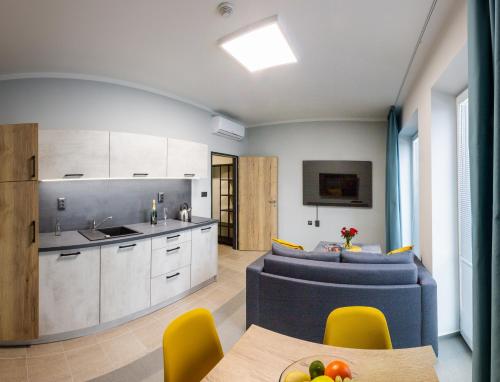 a kitchen and living room with a table and chairs at Penzion Start Ostrava in Ostrava