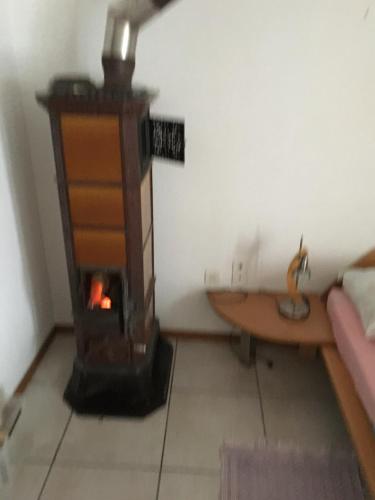 a living room with a wood stove in a room at Girasole Orselina in Orselina