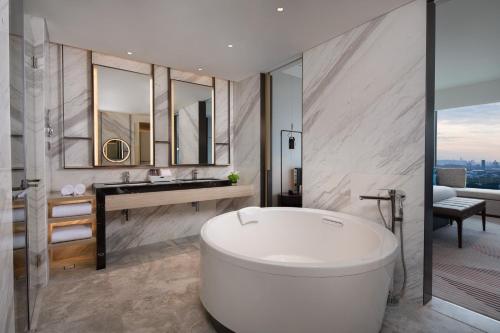 a bathroom with a white tub and a sink at Crowne Plaza Foshan Nanhai-an IHG Hotel-Free Shuttle Bus to Canton Fair in Guangzhou