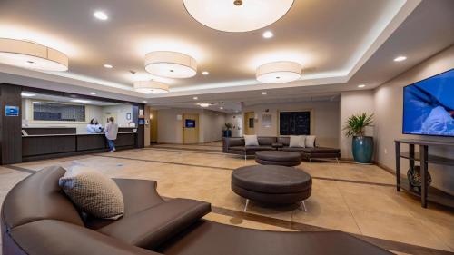 a large lobby with couches and a flat screen tv at Candlewood Suites - Dumfries - Quantico by IHG in Dumfries