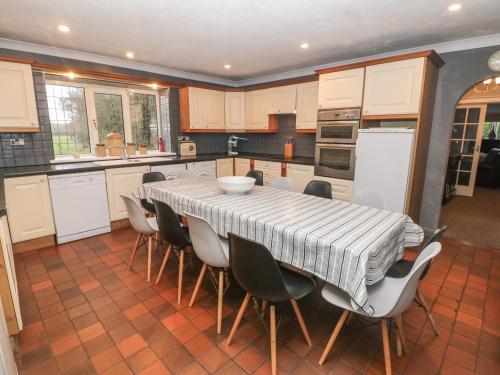 a kitchen with a table and chairs in a kitchen at The Old Barn in Alton